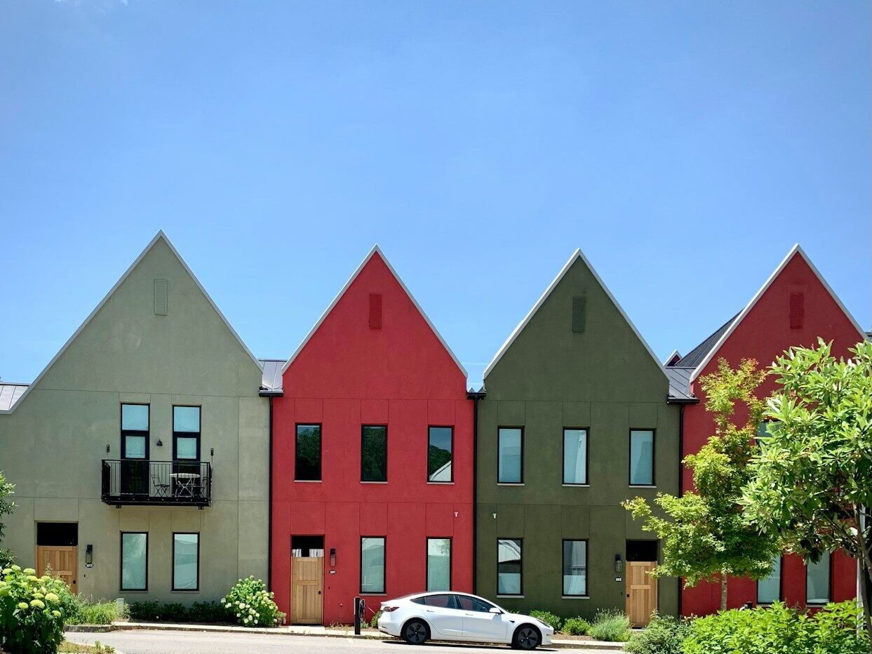 a car parked in front of a row of houses